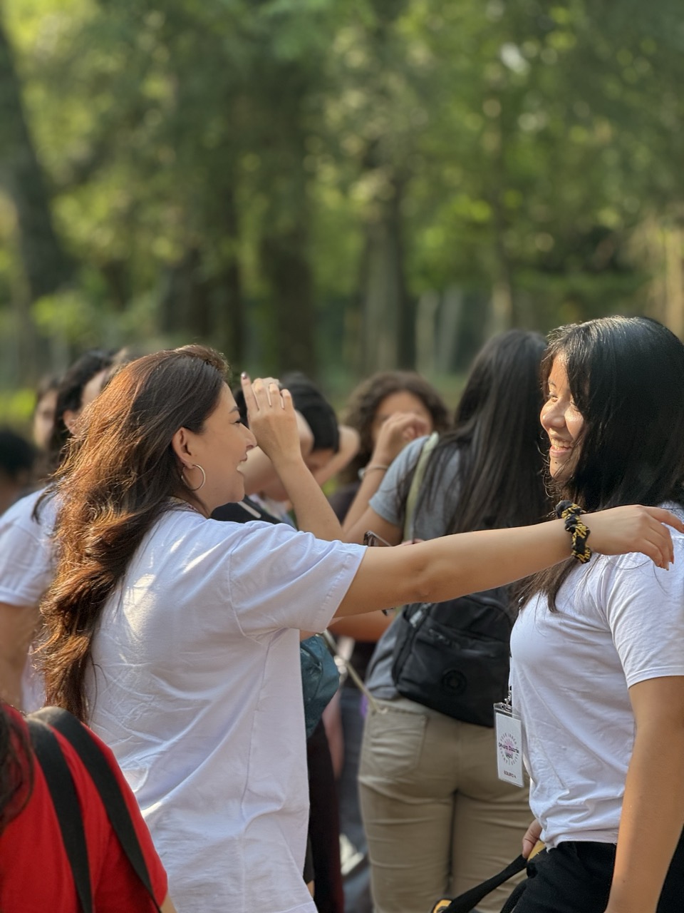 Líder abrazando a una participante con una sonrisa